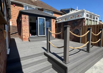 Completed garden landscaping Braintree - new deck with rope handrail leading to patio